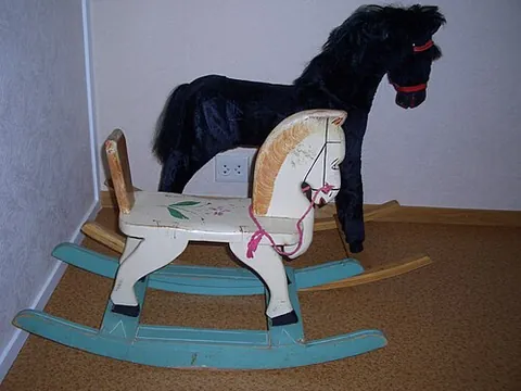 rocking horse: a child’s toy consisting of a (usually wooden) horse mounted on a rocker or swing