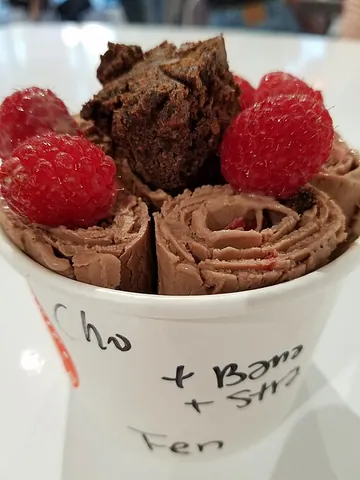 rolled ice cream: a sweetened frozen dessert resembling ice cream or gelato, formed into a rolled shape by stirring...