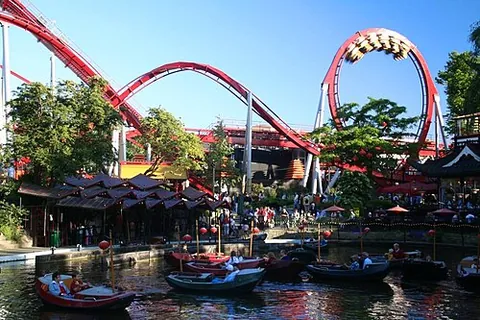 rollercoaster: an amusement ride consisting of a train on a track that rises, falls, twists and turns