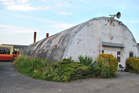 romney hut: a prefabricated semicylindrical steel structure used by the military for storage or as a workshop