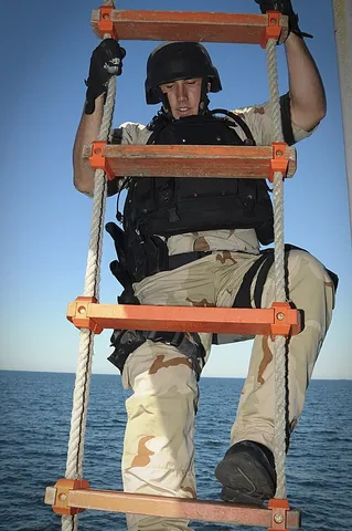 rope ladder: a flexible ladder, constructed of rope, often with wooden rungs, suspended from the top