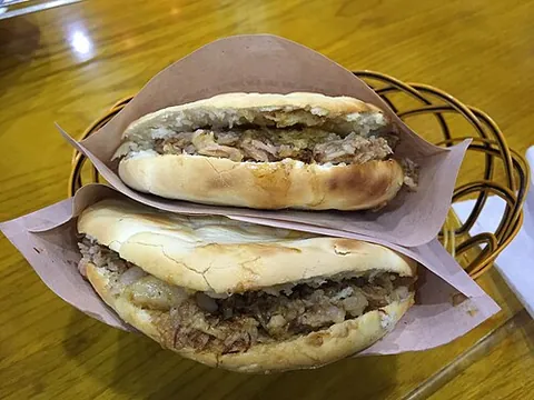 roujiamo: a Chinese meat sandwich, usually containing pork that has been stewed in a seasoned soup,...