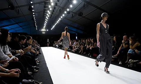 runway model: a person who poses to display clothing by walking along a narrow stage in front of an audience