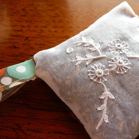 sachet: a small scented cloth bag filled with fragrant material such as herbs or potpourri