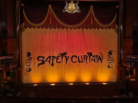 safety curtain: a fireproof curtain which can be lowered to stop the spread of fire between the auditorium and the...