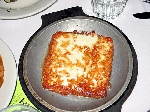 saganaki: any of various Greek dishes cooked in a small frying pan, especially an appetizer of pan-seared...