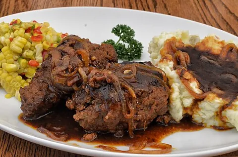 salisbury steak: ground beef, mixed with egg, milk, breadcrumbs and seasonings and made into patties and cooked