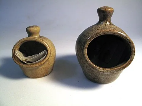 salt pig: a kitchen utensil, in the form of a broad container with an open front, used for holding salt