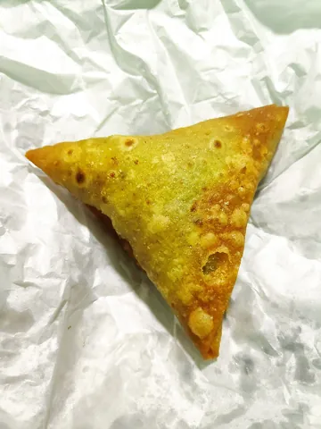 samosa: a South Asian snack consisting of a deep-fried triangular turnover filled with vegetables...