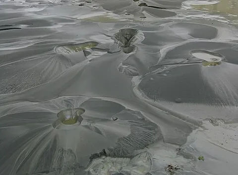 sand boil: an eruption of water through a bed of sand due, for instance, to seismic activity, or to...