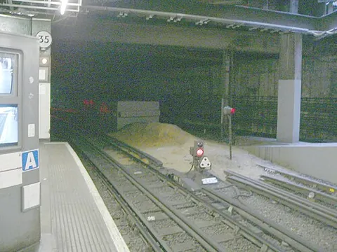 sand drag: a pile of sand or earth at the end of a siding or bay platform, intended to stop trains that...