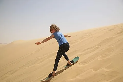 sandboarding: a recreational activity resembling snowboarding but performed on sand instead of snow