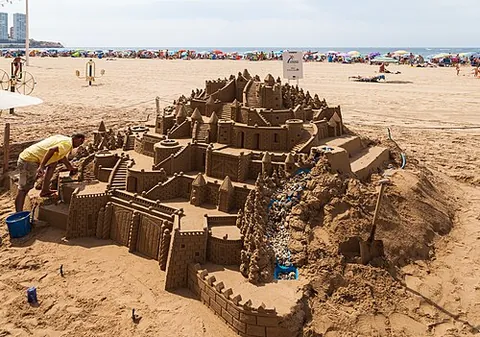 sandcastle: a sculpture made of sand and resembling a miniature castle; typically, but not always, made for fun...