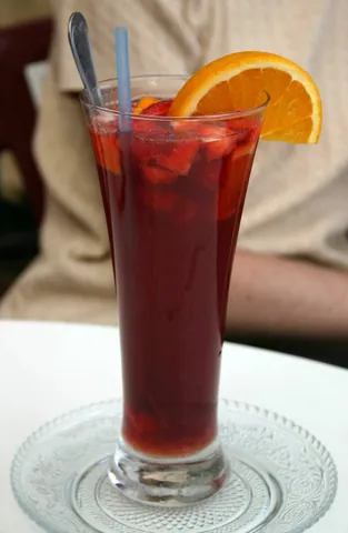 sangria: a cold drink, originating in Spain, consisting of red or white wine, brandy or sherry, fruit juice,...