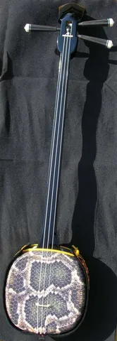 sanshin: a three-stringed instrument of Okinawan origin, the precursor to the shamisen