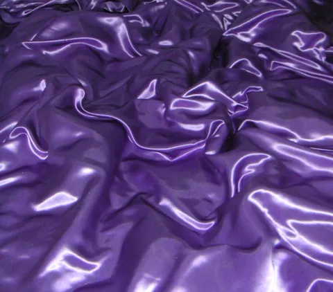 satin: a cloth woven from silk, nylon or polyester with a glossy surface and a dull back. (The same...
