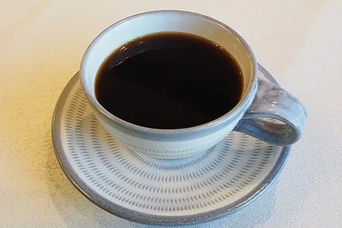 saucer: a small shallow dish to hold a cup and catch drips