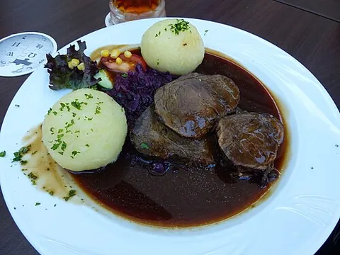 sauerbraten: a German dish of roasted marinated horsemeat or (now more frequently) beef or pork