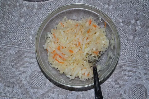 sauerkraut: a dish made by fermenting finely chopped cabbage