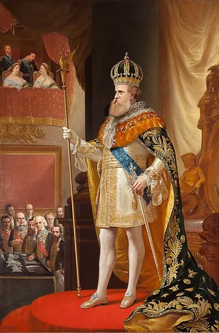 sceptre: an ornamental staff held by a ruling monarch as a symbol of power