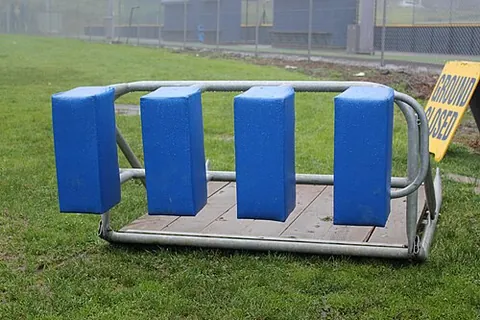 scrum machine: a padded, weighty device against which a pack of rugby football forwards can practice scrummaging...