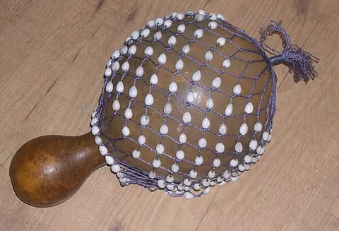 sekere: a musical instrument consisting of a gourd surrounded by a net of beads