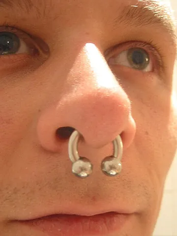 septum piercing: a nose piercing that goes through the nasal septum