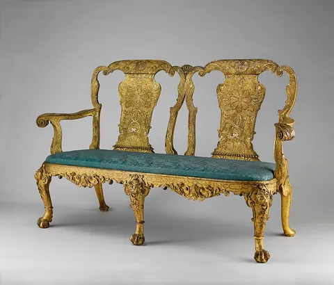 settee: a long seat with a back, made to accommodate several persons at once; a sofa