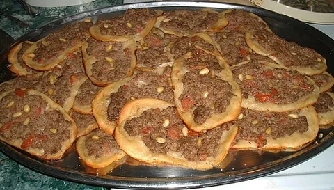 sfiha: an Arab pizza-like dish, traditionally an open-faced meat pie made with ground mutton