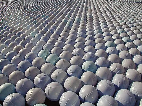 shade ball: a small plastic sphere floated in large numbers on top of a reservoir, pool, etc. to slow...