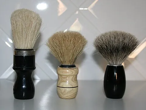shaving brush: a small brush used to create a lather from shaving cream or shaving soap and apply it to the face...