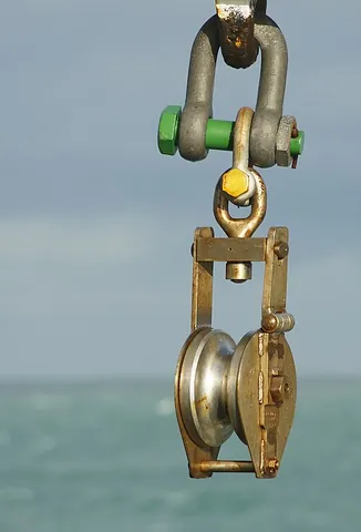 sheave: a wheel having a groove in the rim for a rope to work in, and set in a block, mast, or similar; the...