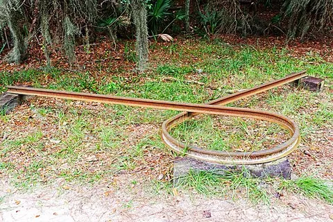sherman necktie: a segment of rail that has been heated and twisted into a loop, as a means of destroying a railway
