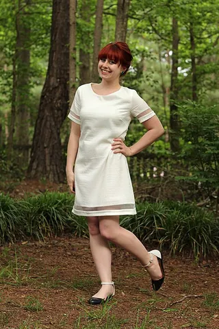shift dress: a loose fitting dress that falls between midthigh and the knee