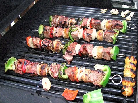 shish kebab: a dish made of small pieces of meat, with or without vegetables, which are skewered on a wooden or...