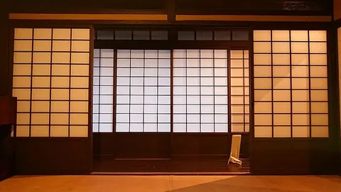 shoji: a door or partition consisting of a wooden frame covered in rice paper, used in traditional...