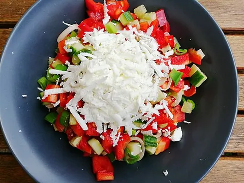 shopska salad: a Bulgarian salad made from tomatoes, cucumbers, onions or scallions, peppers, sirene cheese, and...