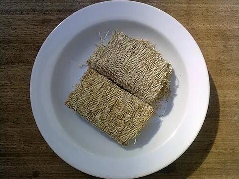 shredded wheat: a breakfast cereal made from whole-wheat and formed into pillow-shaped biscuits