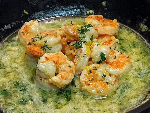 shrimp scampi: a dish of shrimp sauteed in a sauce of butter, garlic, white wine, and lemon juice