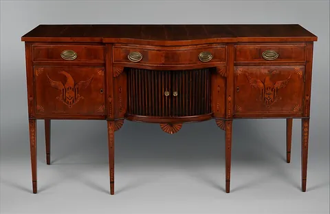 sideboard: a piece of dining room furniture having drawers and shelves for linen and tableware; originally for...