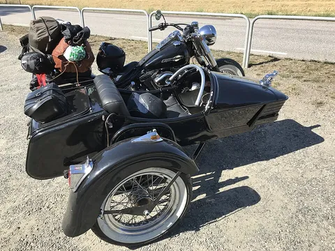 sidecar: a one-wheeled attachment to the side of a motorcycle to allow for a separate seat for a passenger...