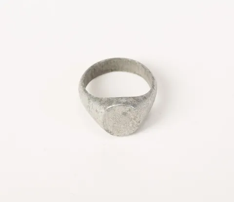 signet: an object (especially a ring) formerly used to impress a picture into the sealing wax of a document...