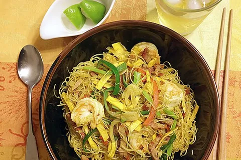 singapore-style noodles: a Cantonese dish of stir-fried cooked rice vermicelli with meat, vegetables, scrambled eggs, and...