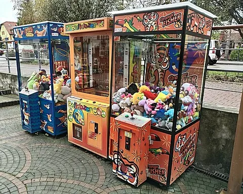 skill tester: a box of prizes, encased in glass, and equipped with a mechanical arm with a claw that a hopeful...