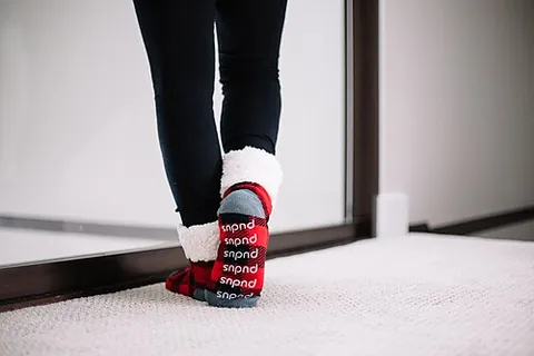 slipper sock: a sock with a soft leather or vinyl sole sewn onto it, used as indoor footwear