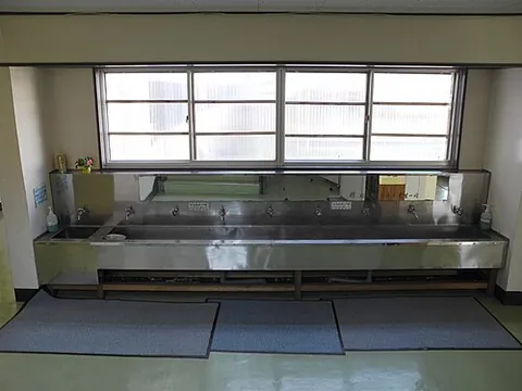slop sink: a large sink made of durable material such as concrete or metal, made for cleaning large objects or...