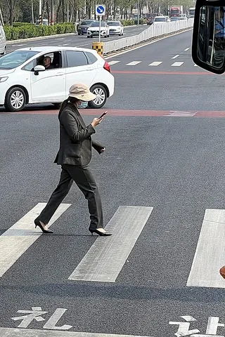 smartphone zombie: a distracted pedestrian who is only paying attention to their smartphone