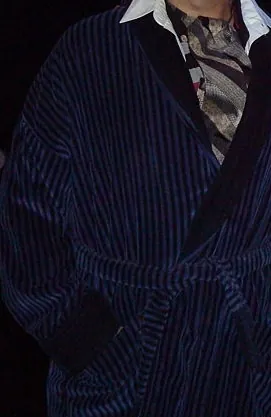 smoking jacket: a men's jacket designed to be worn while smoking tobacco, typically made of soft fabric with a tie...
