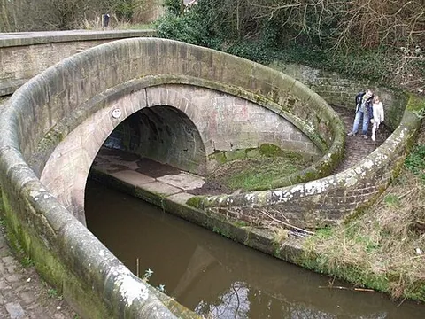 snake bridge: a curved or spiral bridge over a canal designed to allow a horse towing a boat to cross the canal...