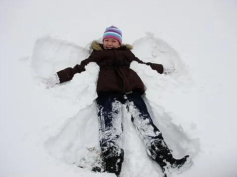 snow angel: a design made in fresh snow by lying on one's back and moving the arms up and down and the legs...